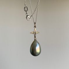 Shades of green and gray cascade subtly down this ombre Tahitian pearl. 18k white gold Tahitian pearl 7/16" x 5/8" Diamond accent Chain is 18" long Star Cross, Green And Gray, Newport Ri, Tahitian Pearls, Shades Of Green, Newport, Cross Pendant, Green And Grey, Pearl Earrings