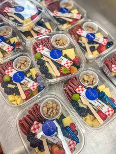 several plastic containers filled with different types of food on top of a metal countertop