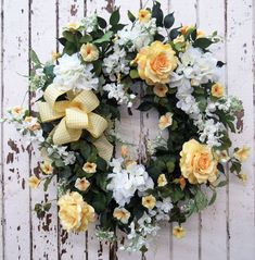 a wreath with yellow and white flowers on it