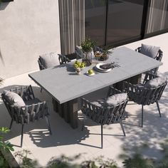 an outdoor dining table and chairs set up outside