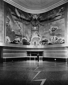 an empty room with large paintings on the wall and floor in black and white photo