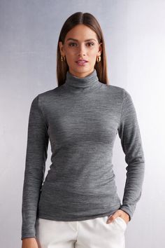 Long sleeve high collar top in 100% natural fabric with cotton against the skin and a soft and warm wool and silk blend exterior. Very comfortable breathable fabric suitable for the coldest weather but also perfect for the most delicate and sensitive skin. Very versatile basic line ideal either worn on its own or underneath a shirt or jacket. Regular fit.
The model is 5’ 9” (175 cm) tall and is wearing a size S. Fitted Plain Tops For Winter, High Stretch Gray Tops For Winter, High Stretch Gray Top For Winter, Long Sleeve Merino Wool Turtleneck For Fall, Merino Wool Long Sleeve Turtleneck For Fall, Winter Long Sleeve Merino Wool Turtleneck, Elegant Gray Winter Tops, Elegant Gray Winter Top, Winter Merino Wool Long Sleeve Turtleneck