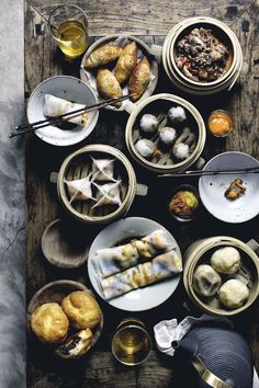 a table topped with plates and bowls filled with food