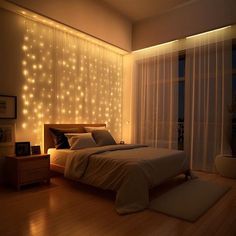 a bedroom with lights on the wall and a bed in front of a large window