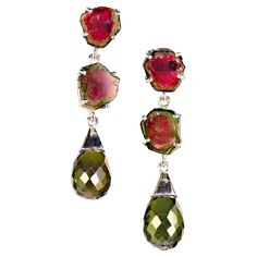 Discover the enchanting allure of these handmade Tourmaline earrings, a must-have accessory for any gemstone lover! Featuring a stunning design with two beautifully crafted watermelon tourmaline slices stacked one above the other, these earrings are elegantly finished with a dazzling faceted green tourmaline briolette hanging gracefully below. Measuring 1.5 inches in length, they are the perfect statement piece to add a touch of sophistication to any outfit. Why Choose Tourmaline? Tourmaline is Red Tourmaline, Tourmaline Earrings, Watermelon Slices, Blue Tourmaline, Classic Earrings, Sterling Silver Dangle Earrings, Red Earrings, Watermelon Tourmaline, Blue Quartz