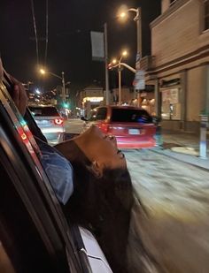 a man sitting in the back seat of a car while talking on a cell phone