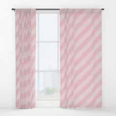 a pink and white striped curtain hanging in front of a window