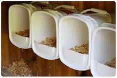 three bins with food in them are hanging on the wall next to each other