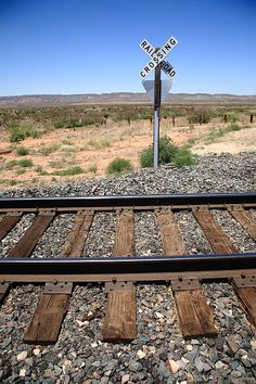 a railroad crossing sign in the middle of nowhere