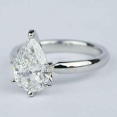 a white gold engagement ring with a pear shaped diamond