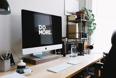 a person sitting at a desk in front of a computer with the word do more on it