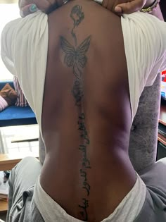 a woman with a tattoo on her back