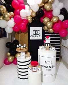 a chanel themed birthday party with balloons and cake