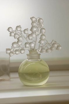 a glass vase with some flowers in it