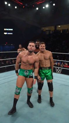 two men standing next to each other in a wrestling ring