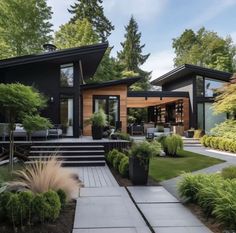 a modern house in the middle of a lush green yard with steps leading up to it