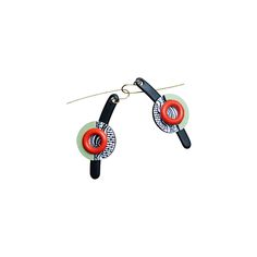 two pairs of black and red earrings hanging from hooks on a white background with clippings