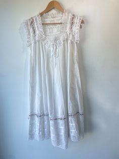 Vintage Floral and Lace Dress. Seriously one of the most stunning dresses we've ever encountered. Has the sweetest details, a bit sheer, and midi length. No tags but fits like a Large, feels like cotton. Hand wash cold. Approximate measurements:Underarm to underarm: 18"Length: 39" White Sleeveless Cottagecore Dress, Cottagecore Daywear Dress With Lace Trim, Cottagecore Lace Trim Dress For Daywear, Cottagecore Day Dress With Lace Trim, Cottagecore Dresses With Lace Trim For Daywear, Cotton Midi Dress With Broderie Anglaise For Daywear, Cotton Midi Dress With Lace Trim, Elegant White Cotton Prairie Dress, Cotton Prairie Dress With Lace Trim For Summer