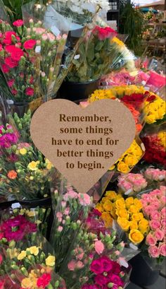 flowers are arranged in buckets with a sign that says, remember some things have to end for better things to begin