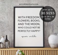 a framed poster with the quote, printable style is displayed on a shelf next to vases