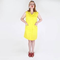 This dress has made it since the 1960s without being used, despite its cuteness! The bright yellow cotton poplin dress is a slightly A-line shift dress in cut. It has a sailor collar and patch pockets with glossy red, white and blue braid. There are yellow plastic buttons down the front. The dress has the union label used 1963-74 and a hangtag with "K-10 Ladies & Girls". Unlined.  CONDITION: Mint, unused and with its original tag. SIZE: Labeled size medium, which seems right to me.  Bust-40" Waist-42" Hip-43" Back of neck to hem-36.75" Please note: I measure the dimension of the item itself, and you will need to consider what size you would want the item to be to fit well on you. ❤️  10% of all denisebrain sales go toward saving endangered manatees through the Save the Manatee Club--Thank Retro Yellow Cotton Dress, Blouse Nylon, Cotton Poplin Dress, Heavy Coat, Sailor Collar, Poplin Dress, Dress Clothes For Women, Red White And Blue, Cotton Poplin