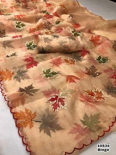 an image of a table cloth with leaves on it