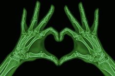 two green hands making a heart shape with their fingers in the shape of a hand