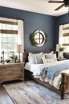 a bedroom with blue walls and white bedding