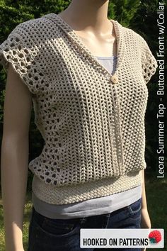 a mannequin wearing a knitted sweater with holes in the front and back