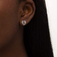 With double the love, these heart stud earrings add shimmer to most any attire. Created in sterling silver, each earring features a pair of heart-shaped outlines - one smaller and polished interlocked top-to-bottom with a larger outline. Beaded details and diamond accents glisten along the lower heart. Buffed to a brilliant luster, these post earrings secure comfortably with friction backs. White Gold Double Heart Earrings With Heart Charm, White Gold Double Heart Earrings For Pierced Ears, Valentine's Day Double Heart Fine Earrings, White Gold Double Heart Diamond Earrings, Mother's Day Double Heart Pierced Earrings, Fine Jewelry White Gold Heart Earrings, White Gold Heart Earrings Fine Jewelry, Pierced Heart Earrings Fine Jewelry, Valentine's Day White Gold Double Heart Earrings