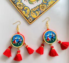 Sicilian handmade jewelry. Unique Sicilian style earrings with two different designs and red tassels. Inspired by Sicilian traditions and the colors of our beautiful Mediterranean island.  The largest pair represents a typical Sicilian couple playing tambourine and volcano Etna on the background: total length is 8 cm / 3,1 inches. Width of the wooden charm 3 cm. The slightly smaller one has a beautiful Etna landscape with a girl dressed in typical ancient Sicilian clothes. Total length is 8 cm/ Sicilian Clothing, Sicilian Traditions, Sicilian Style, Tambourine, Pretty Bags, Jewelry Unique, Traditional Jewelry, Wedding Board, Style Earrings