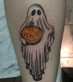 a halloween tattoo with a ghost holding a pumpkin