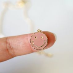 "Beautiful and lovely happy face charm necklace. Made of blush enamel smiley face charm with skinny gold plated brass chain. Soft and warm. Great for a gift, every day or special occasion. Your item will ship in a gift box. Please feel free to contact me if you have any questions. ♥ Length 14\" -20\" chain ♥ Charm 5/8\" x 3/4\" ♥ Gold plated over brass / Blush enamel ♥ Delivery Time Fast shipping within 1 - 3 days ♥ See more Rudiana Accessories Rudiana.etsy.com" Trendy Nickel-free Pink Charm Necklace, Everyday Pink Charm Necklace, Pink Smiley Face Jewelry For Everyday, Everyday Pink Charm Necklaces, Personalized Pink Charm Necklace For Everyday Wear, Personalized Pink Charm Necklace For Everyday, Cute Pink Charm Necklace For Best Friend, Smiley Face Necklace, Preppy Gifts