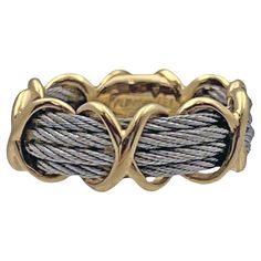 Fred Paris 'Force 10' band ring in 18k yellow gold and stainless steel cable. Four rows of steel cable with six 18 karat yellow gold 'X' design wraps. 5.3mm wide (cables) to approximately 8mm wide (gold X wraps). Signed 'Fred Paris OR750' hand engraved on polished gold interior. Finger size 6.5. Known in Paris, Beverly Hills, New York for their high-end collectible statement pieces, FRED Paris also designed playful every day jewelry such as the 'Force 10' collection. Force 10 was designed from t Henri Samuel, Nautical Motifs, Paris Ring, Bvlgari Ring, Contemporary Jewelry Design, Smart Jewelry, Love Band, Stainless Steel Cable, Gold Interior