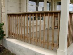 a porch with wooden slats on the side of it and a potted plant in front