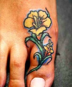 a foot with a yellow flower tattoo on it's left toe and bottom part