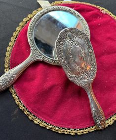 a mirror sitting on top of a red cloth