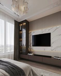 a bedroom with a large tv mounted on the wall