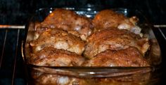 a glass dish filled with meat in an oven