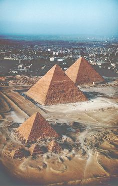 three pyramids in the middle of a desert