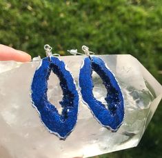 These elegant sapphire blue earrings are intended to look like real geodes. They are accented with silver and are lightweight so they won't bother your ears I am not responsible for any allergic reactions to the earrings. Please be aware that resin is heat resistant up to 135 degrees. These earrings cannot be in the hot full sun shining on them for a long time. For example, I would not wear them to the beach or leave them in a hot car. I am not responsible for earrings that have been deformed or Handmade Blue Geodes For Gifts, Handmade Blue Geodes As Gifts, Handmade Blue Geodes For Gift, Handmade Blue Geodes As A Gift, Sapphire Blue Earrings, Blue Geode, Geode Earrings, Blue Earrings, Handmade Art