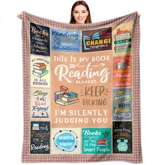 a woman holding up a blanket with books on it