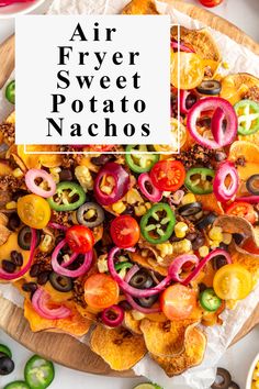 an air fryer sweet potato nachos on a wooden platter with the words air fryer sweet potato nachos above it