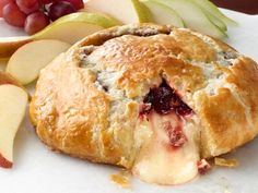 an apple and cranberry pie on a white plate