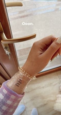 a woman's arm with a bracelet on it and the words nooo written on her wrist