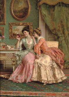 two women in dresses sitting on a couch