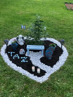 a heart shaped garden in the middle of a yard with rocks and gravel around it