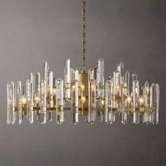 a large chandelier with clear glass tubes hanging from it's center point