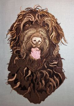 a dog's head is made out of fabric and has been embroidered onto the back of it