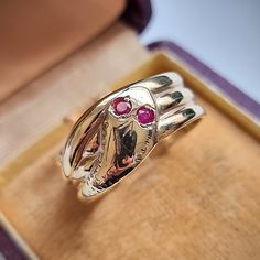 "A fantastic vintage ring shaped as a coiled snake, the head featuring two round rubies to represent the eyes, fully hallmarked and dating to the year 1966. Snake jewellery is said to represent eternity or infinity - it dates back many centuries and remains popular and collectable to this day. Hallmarked as 9ct gold, dated Birmingham 1966. Maker's mark \"C.P.S\" for CPS Jewellery Co Ltd of Vyse Street, Birmingham. The width of the band measures approximately 9.8mm (widest) to 7.0mm (slimmest). The approximate weight is 4.8 grams. Please note that the antique ring box is for display purposes only. Thank you. Ring size T (UK) or 9 5/8 (US) - this ring can be adjusted in size in our workshop. Please get in touch to discuss sizing options and lead time. Please note that for UK to US ring sizes Antique Hallmarked Snake Ring, Antique Snake Ring As Gift, Antique Hallmarked Ruby Ring For Ceremonial Occasion, Vintage Yellow Gold Snake Jewelry, Vintage Engraved Snake Ring As A Gift, Vintage Engraved Snake Ring Gift, Heirloom Hallmarked Snake Ring As Gift, Vintage Snake-shape Jewelry For Formal Occasions, Elegant Hallmarked Snake Ring